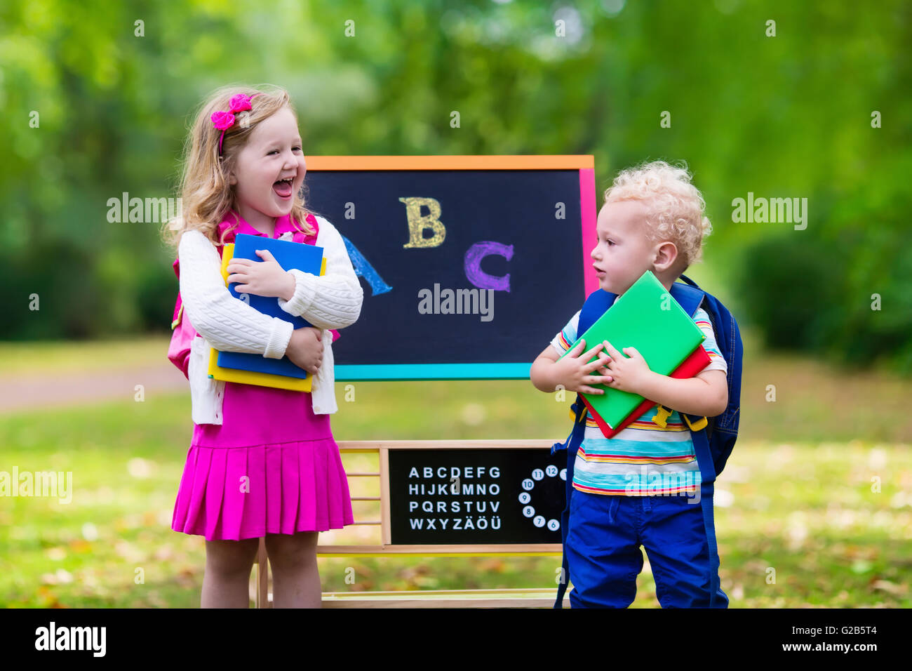 Children happy to be back to school. Preschooler girl and boy with ...