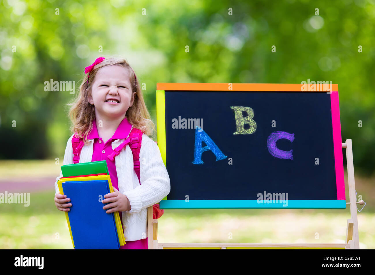 Child happy to be back to school. Funny little preschooler girl with ...