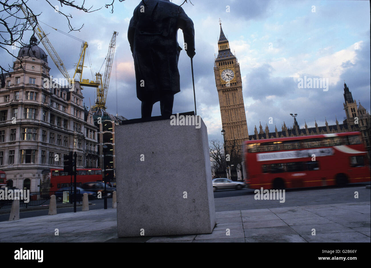 Great Britain London, Westminster, House of parliament with Big Ben and red blurred double decker bus  and Winston Churchill Statue Stock Photo
