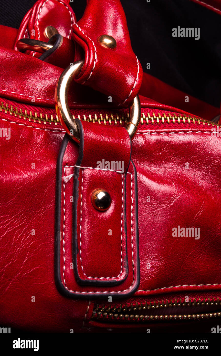 closeup of the fittings on the red leather hand bag Stock Photo