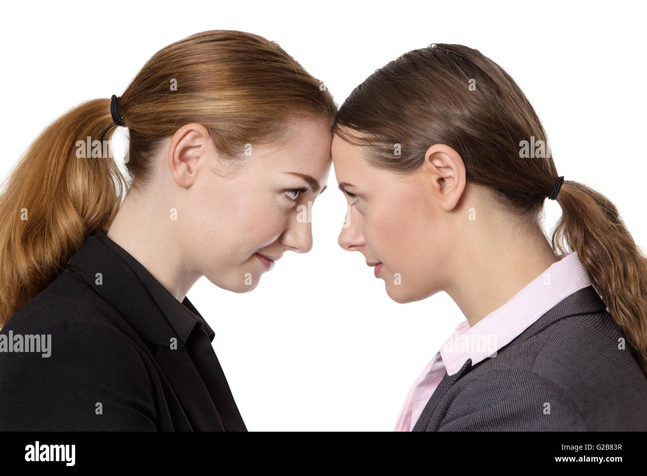 Close up office shot of two businesswomen knocking their heads together. Stock Photo