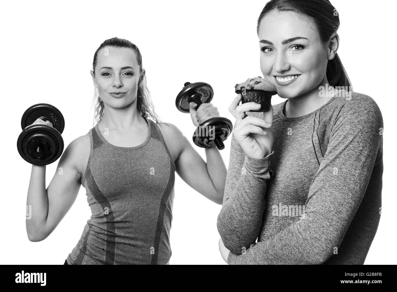 two fitness woman one holding a chocolate muffins the other working out using dumbbells Stock Photo