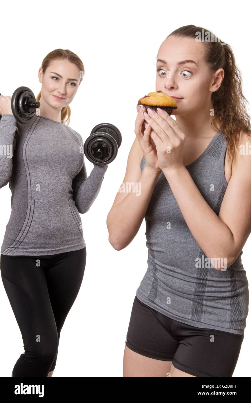 Two Sporty Women Holding Muffin And Dumbbells On White Background Stock Photo