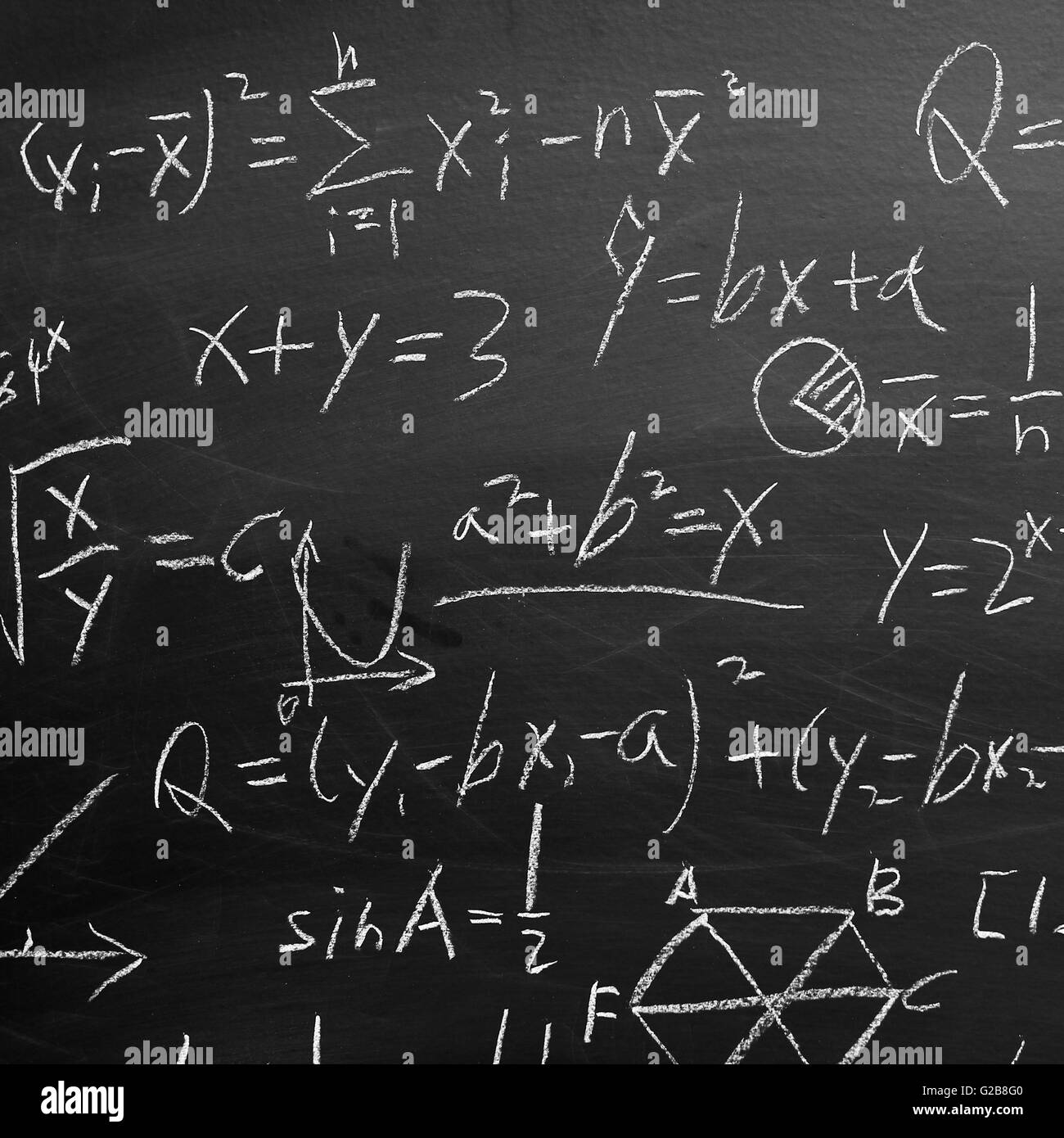 Maths formulas written by white chalk on the blackboard background ...