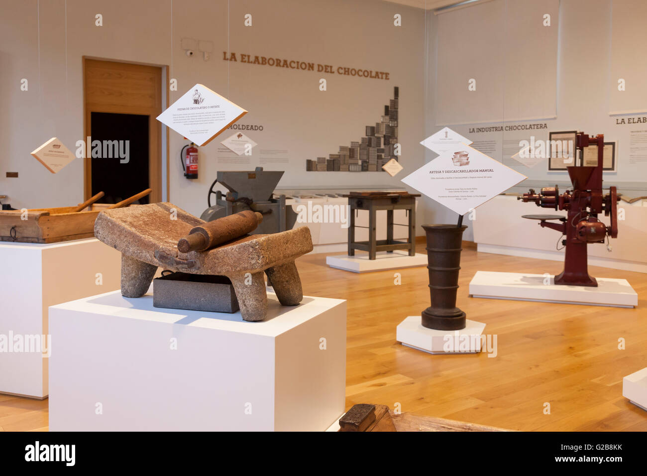 Astorga, Spain: A metete (mealing stone) and other tools used in the processing of cacao on display at El Museo del Chocolate. Stock Photo