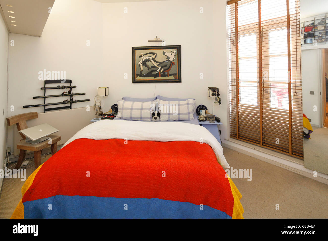 Foley House, Maddox Street. Modern bedroom with bright colourful duvet on bed. Contemporary furniture and decoration. Ceiling to floor window. Stock Photo