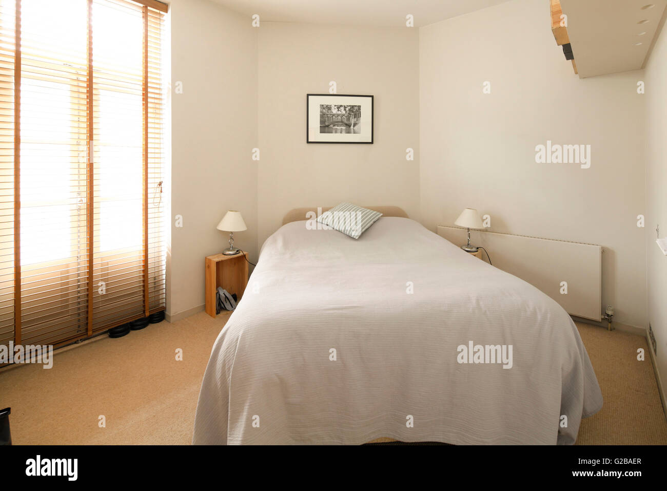 Foley House, Maddox Street. Small bedroom with white bedding and minimal furniture. Stock Photo