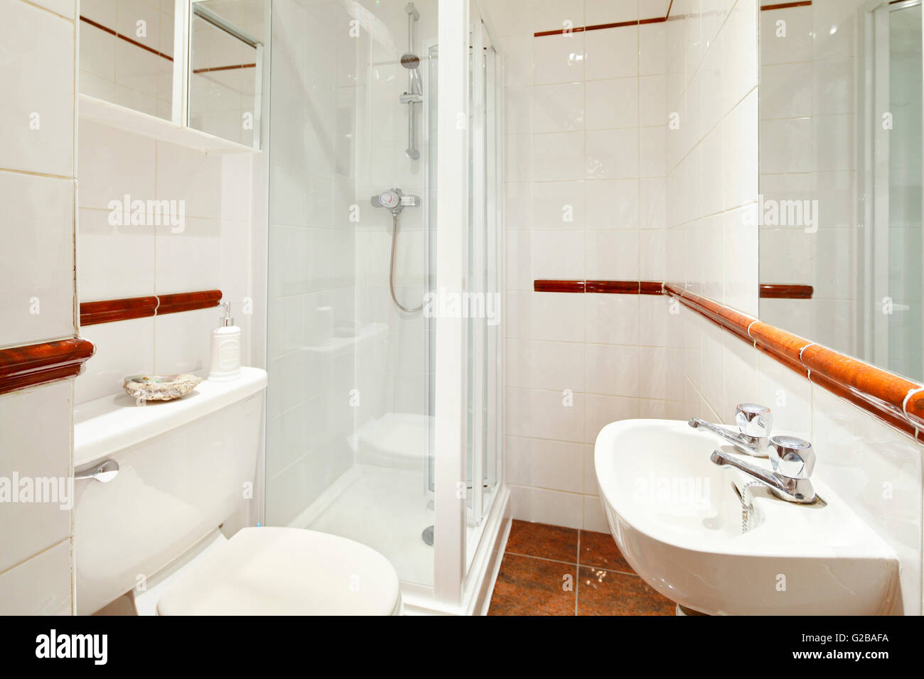 Harrington Gardens. Small modern bathroom with white features and shower cubicle. Stock Photo
