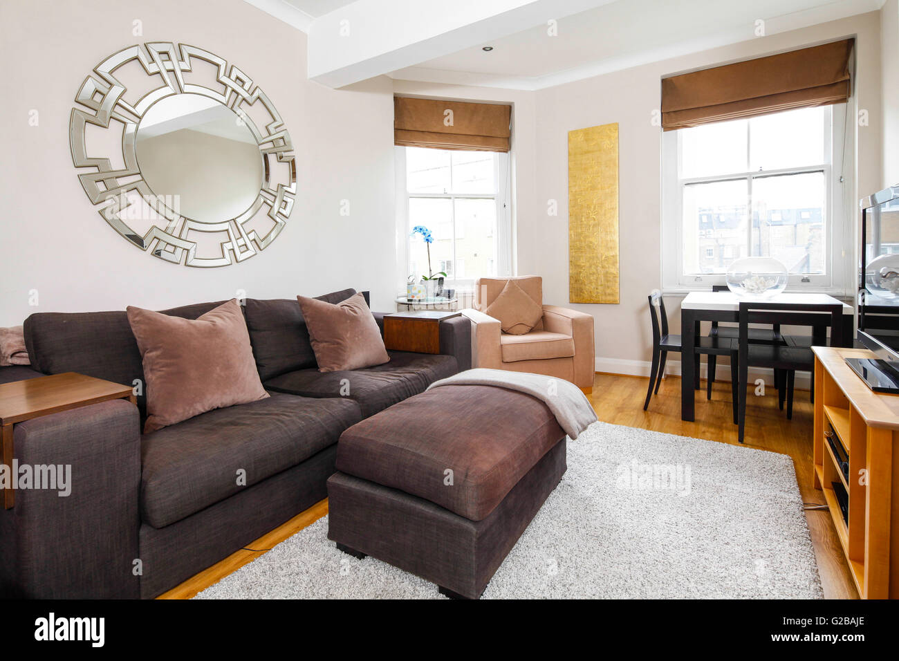 Park House, Harrington Road. Modern clean open plan living and dining room. Mirror hanging above couch. Stock Photo