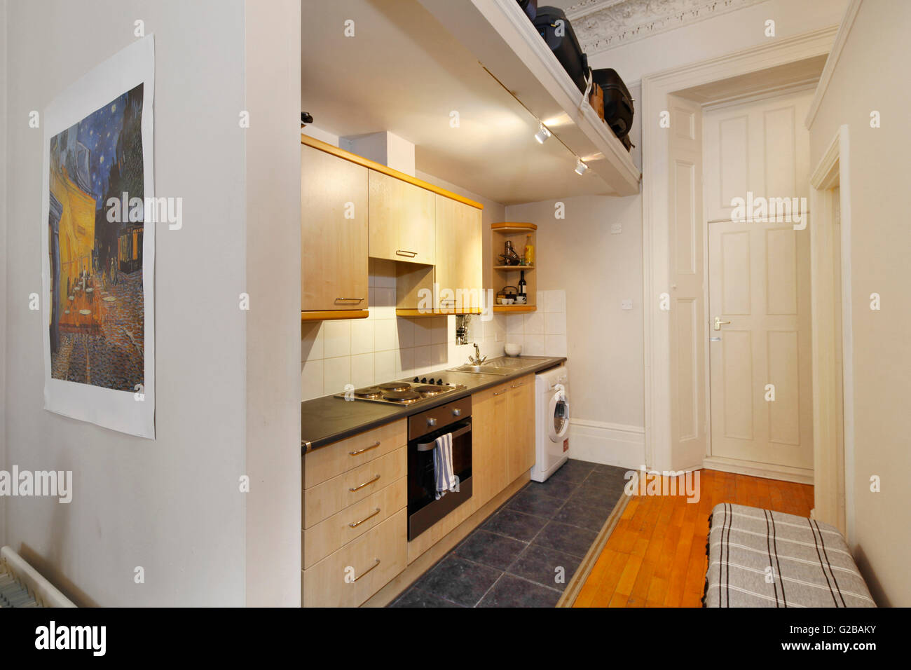 Pembridge Square, Notting Hill. View of a small, old fashioned kitchens. Wood cabinets and white washing machine. Stock Photo