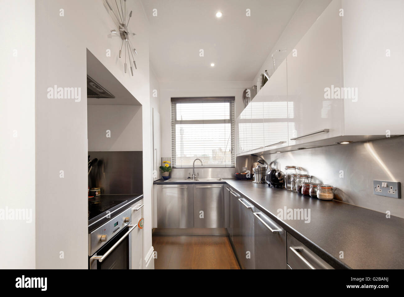 Walden House, Marylebone High Street. Modern kitchen with stainless steel countertops and appliances and white cabinets. Stock Photo