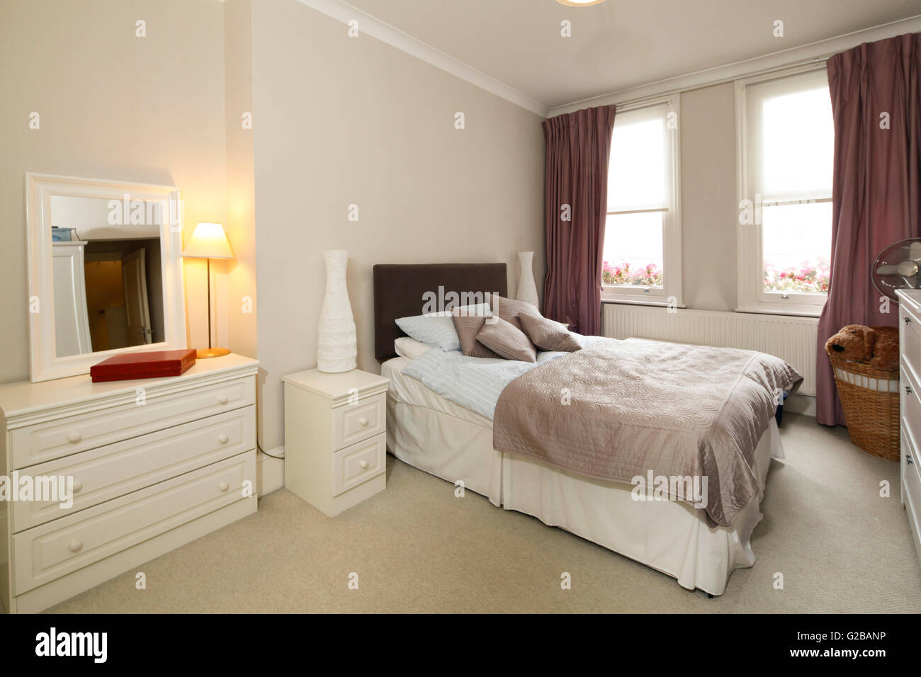 Walden House, Marylebone High Street. Bedroom with traditional, neutral toned furniture and large windows. Stock Photo