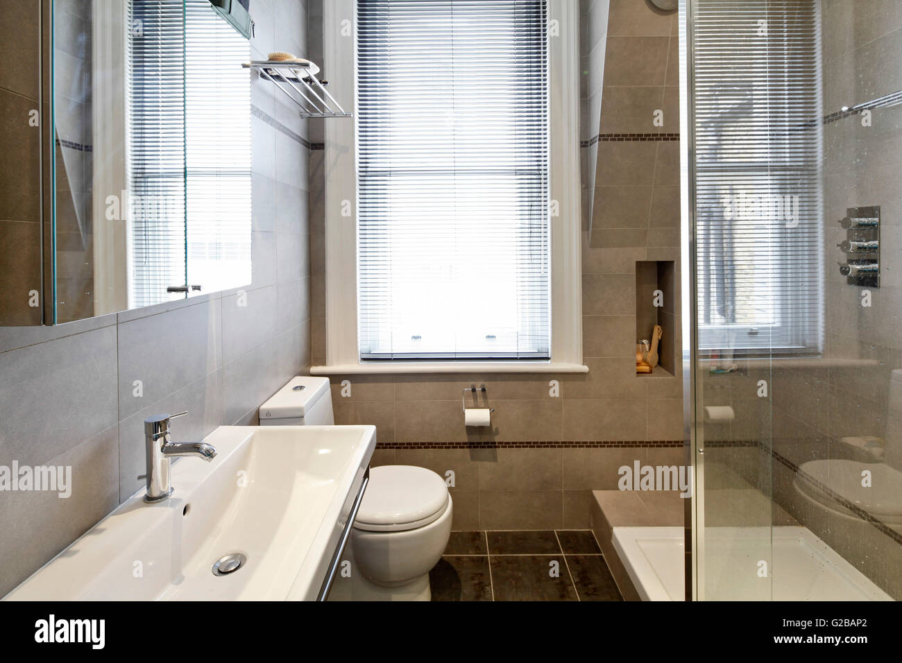 Walden House, Marylebone High Street. Modern bathroom with glass shower door and white features. Stock Photo