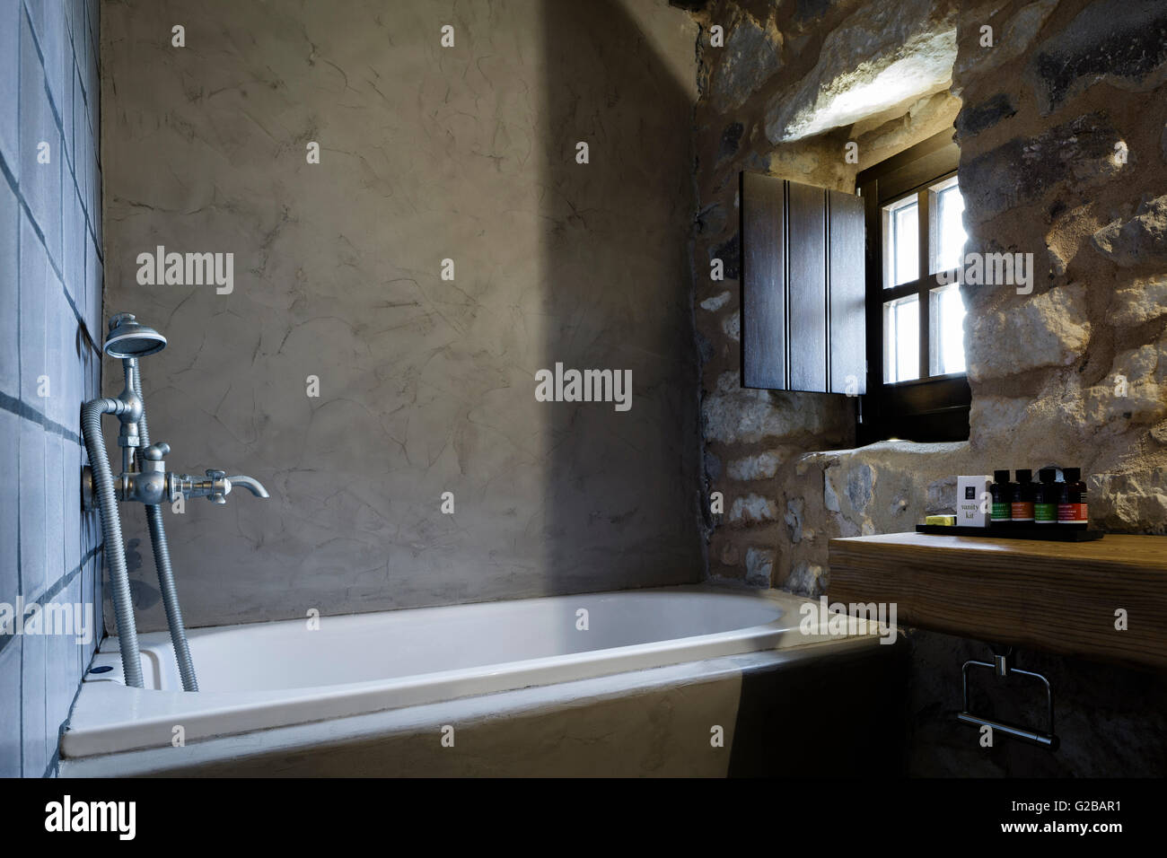 Tainaron Blue Retreat in Mani, Greece. View of a bathroom with tub and stone walls. Stock Photo