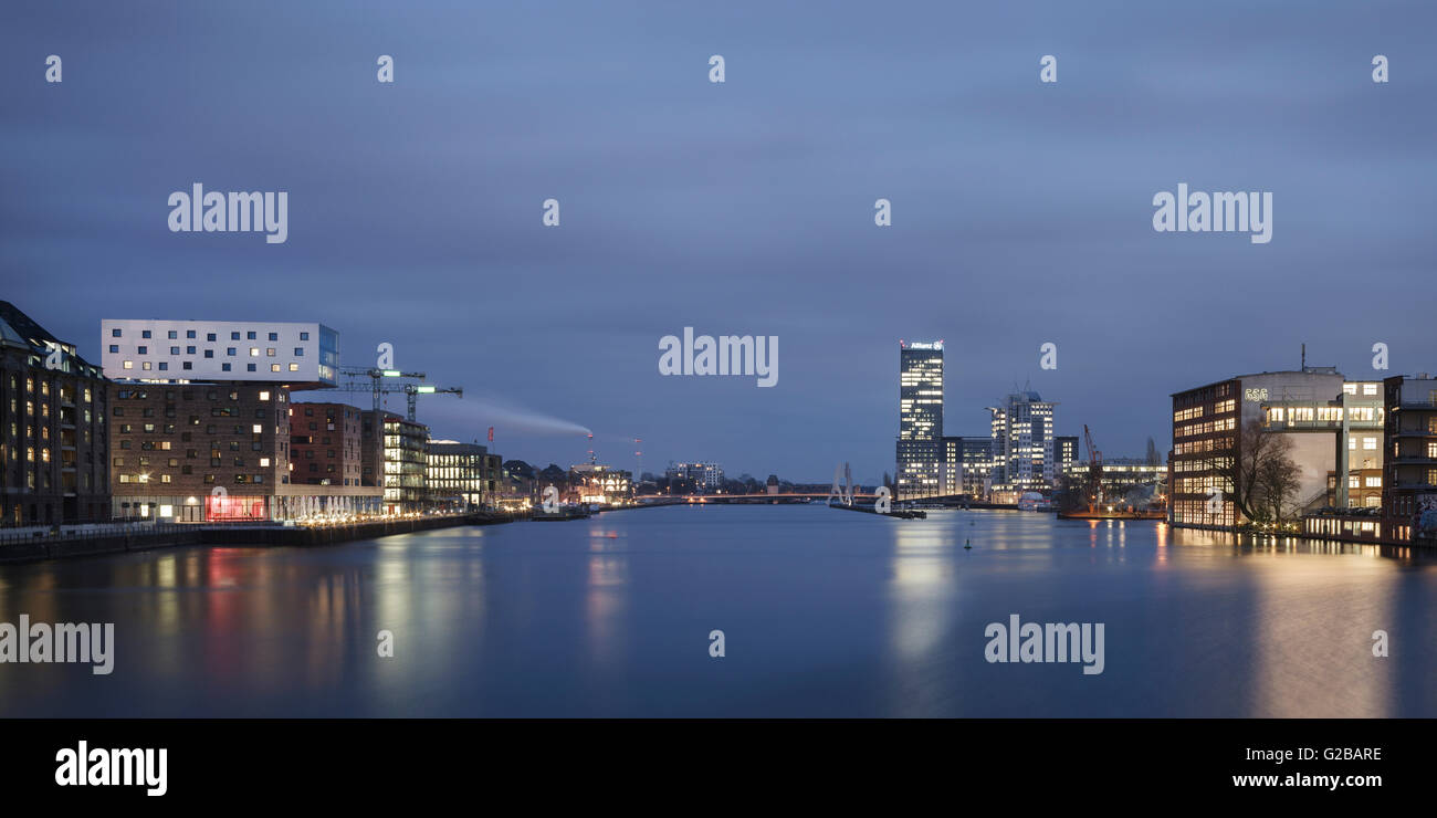 Musik & Lifestyle Hotel nhow, Berlin, Germany, by NPS Tchoban Voss. Distant view at night of the hotel nhow across the river. Stock Photo