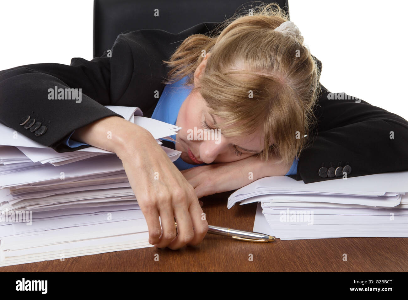 Exhausted Business Woman Has Fallen Asleep On The Desk Behind Some Piles Of Paperwork Stock Photo Alamy