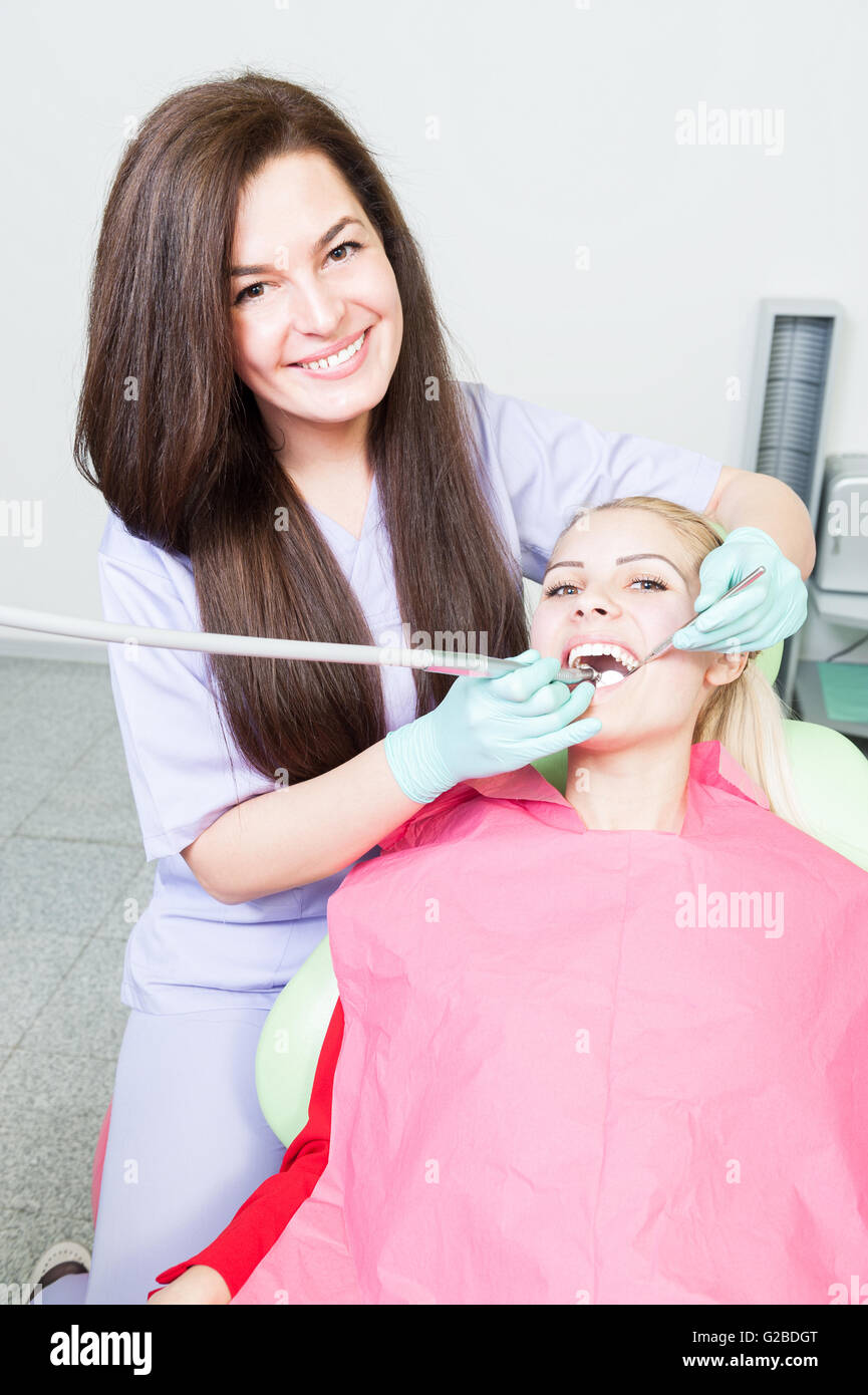 Periodic orthodontic exam concept with beautiful women dentist and