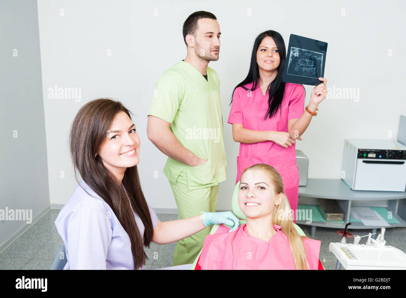 Dental assistance concept with dentist team and happy patient Stock