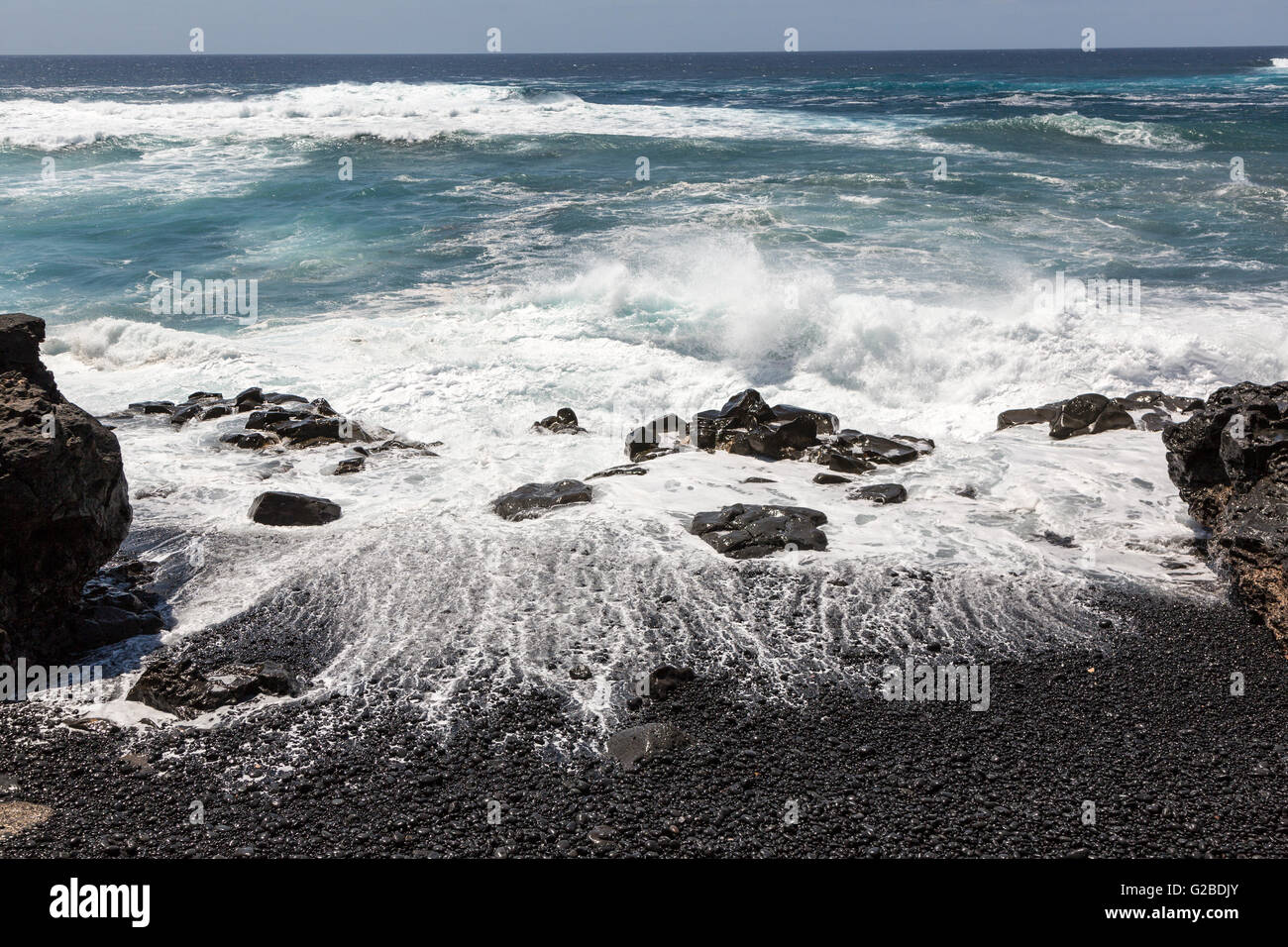 Waves breaking on black volcanic rock on beach, Playa Janubio, Lanzarote, Canary Islands, Spain Stock Photo