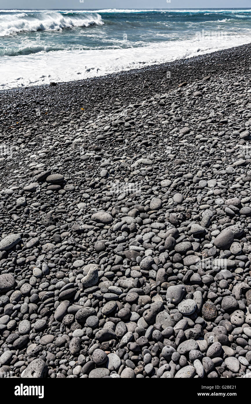 Worn black volcanic rock pebbles on beach, Playa Janubio, Lanzarote, Canary Islands, Spain Stock Photo