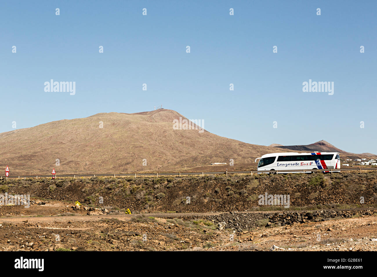 Tour bus in volcanic landscape, Lanzarote, Canary Islands, Spain Stock Photo