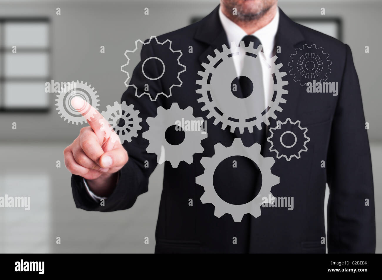 businessman-finger-touching-a-modern-digital-gear-on-touchscreen-as