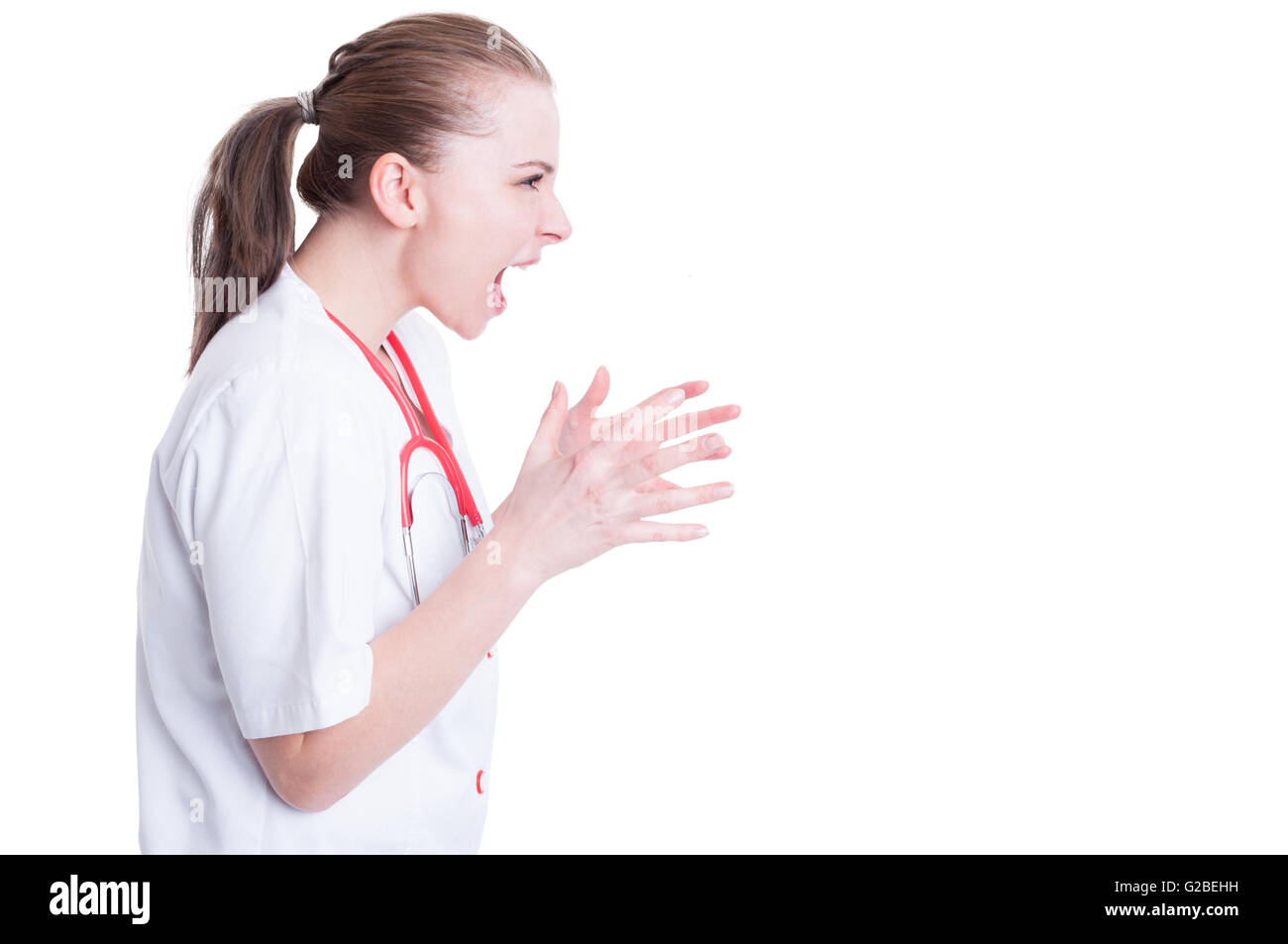 Furious female doctor model screaming and arguing with someone with mouth wide open with copypaste isolated on white background Stock Photo