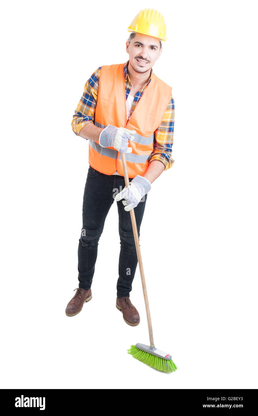 Cheerful engineer sweeping the floor with a broom as cleaning concept isolated on white Stock Photo