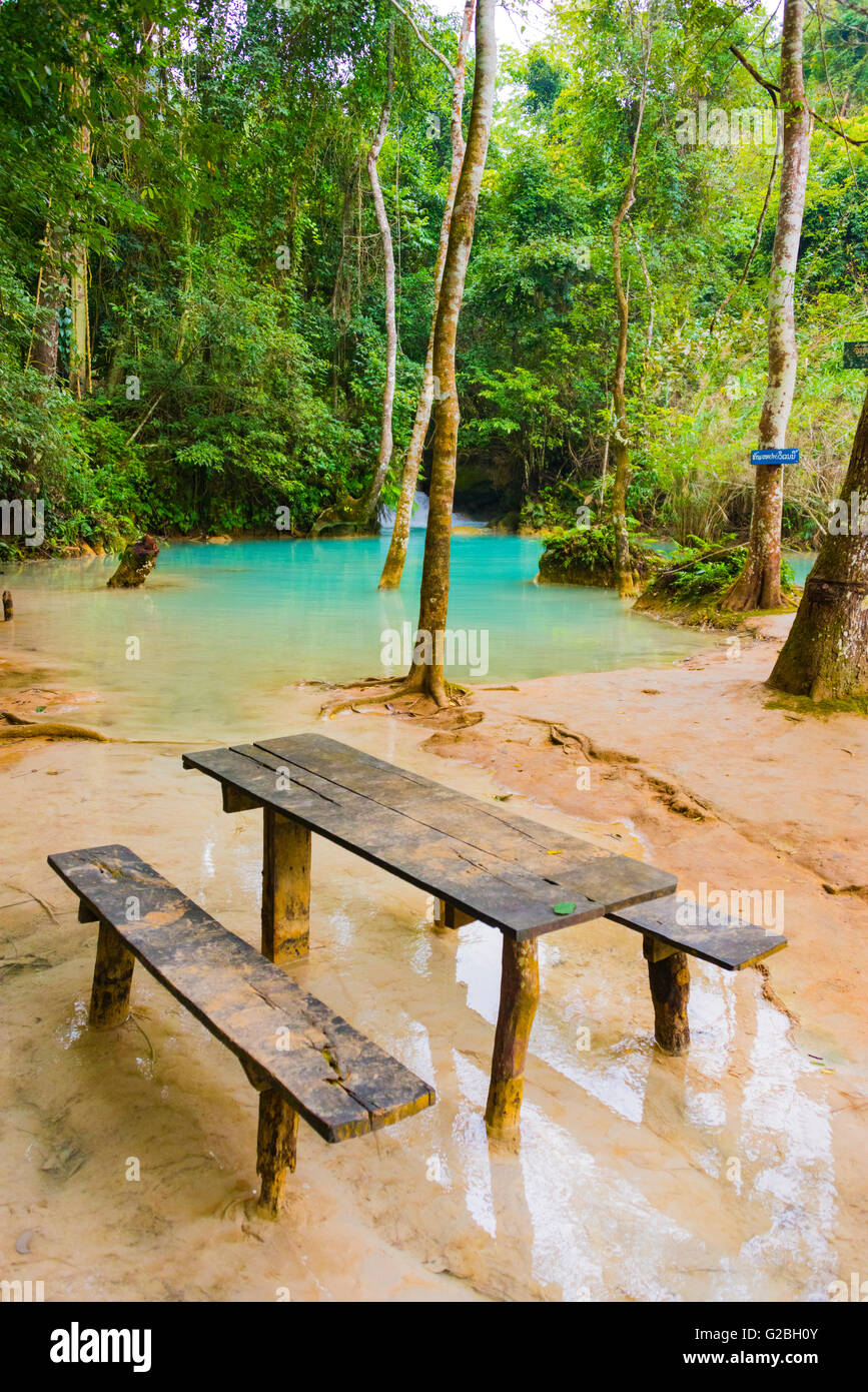 Wooden table in turquoise water, Tat Kuang Si waterfalls, Luang Prabang, Luang Prabang Province, Laos Stock Photo