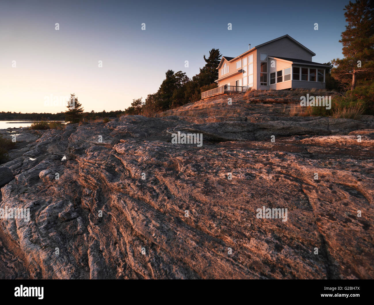 Cottage House On A Rocky Shore In Evening Light Georgian Bay