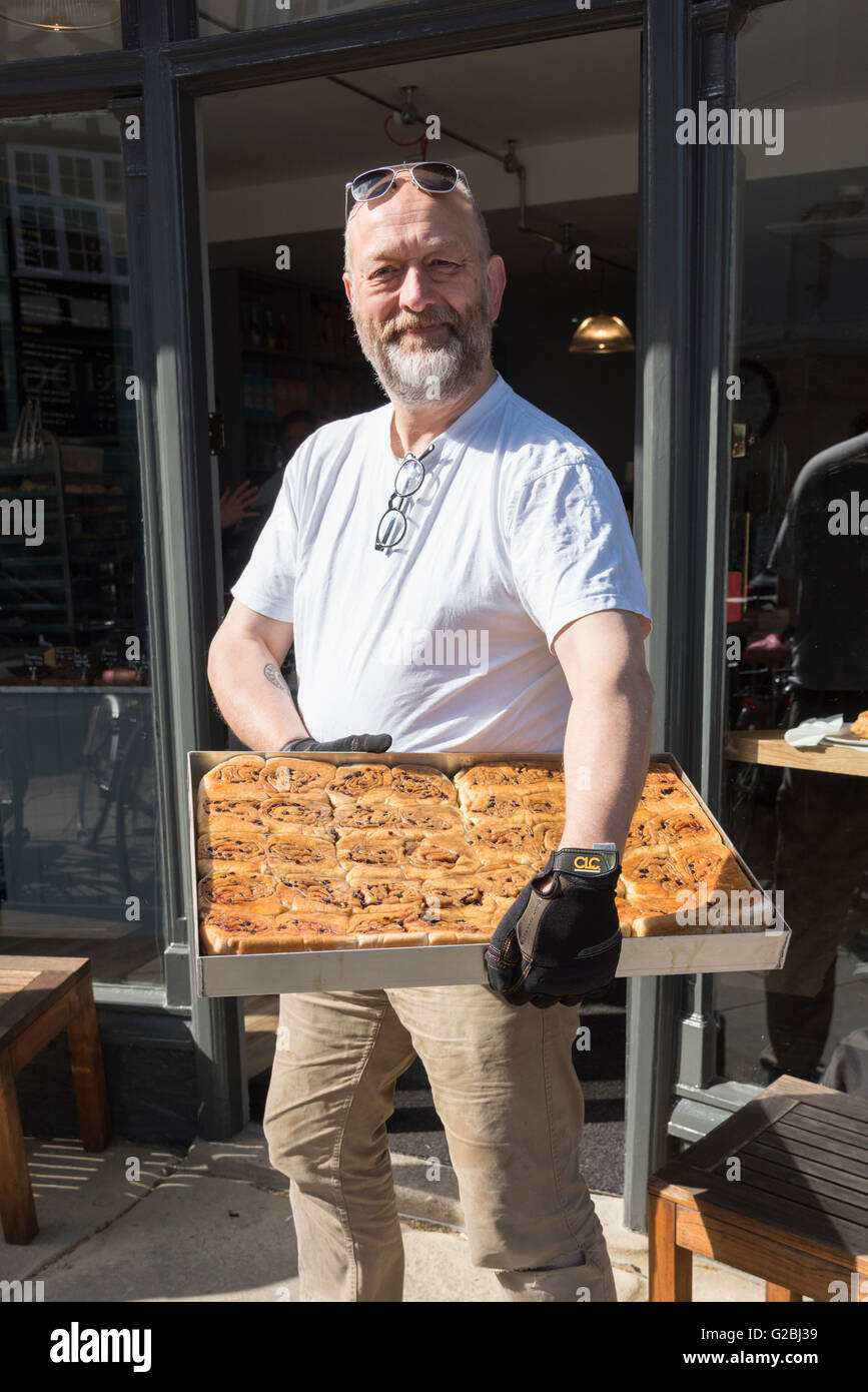 Tim Hayward the owner of the new Fitzbillies cafe and restaurant Cambridge UK holding a tray of chelsea buns Stock Photo