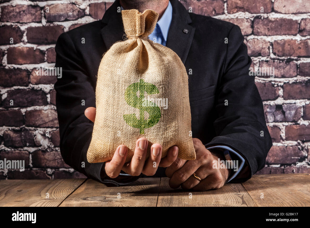 Man holding a big sack of money Stock Photo - Alamy