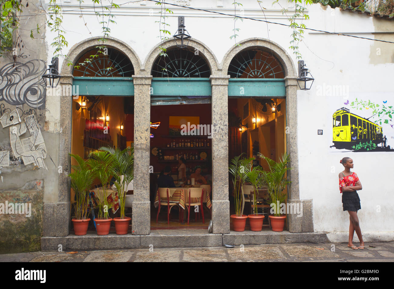 Girl standing outside restaurant, Santa Teresa, Rio de Janeiro, Brazil Stock Photo