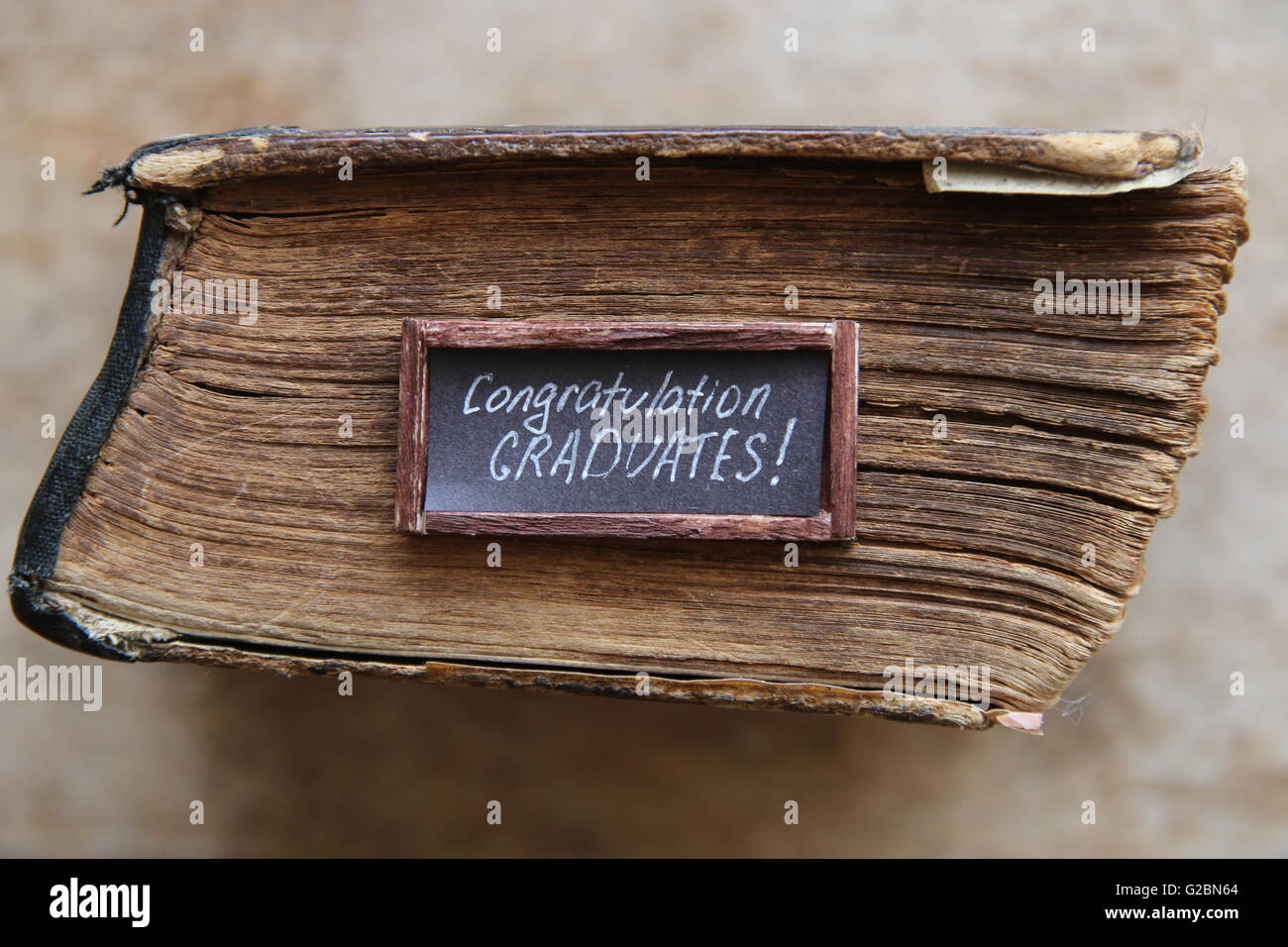congratulations graduates text and vintage book Stock Photo
