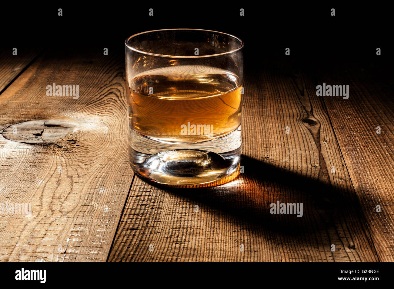 Glass of alcohol on wood table with shadow Stock Photo Alamy