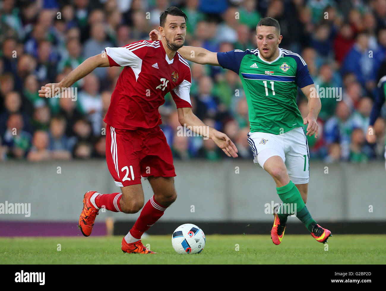 Belarus' Egor Filipenko (left) and Northern Ireland's Conor Washington battle for the ball during the International Friendly at Windsor Park, Belfast. Stock Photo