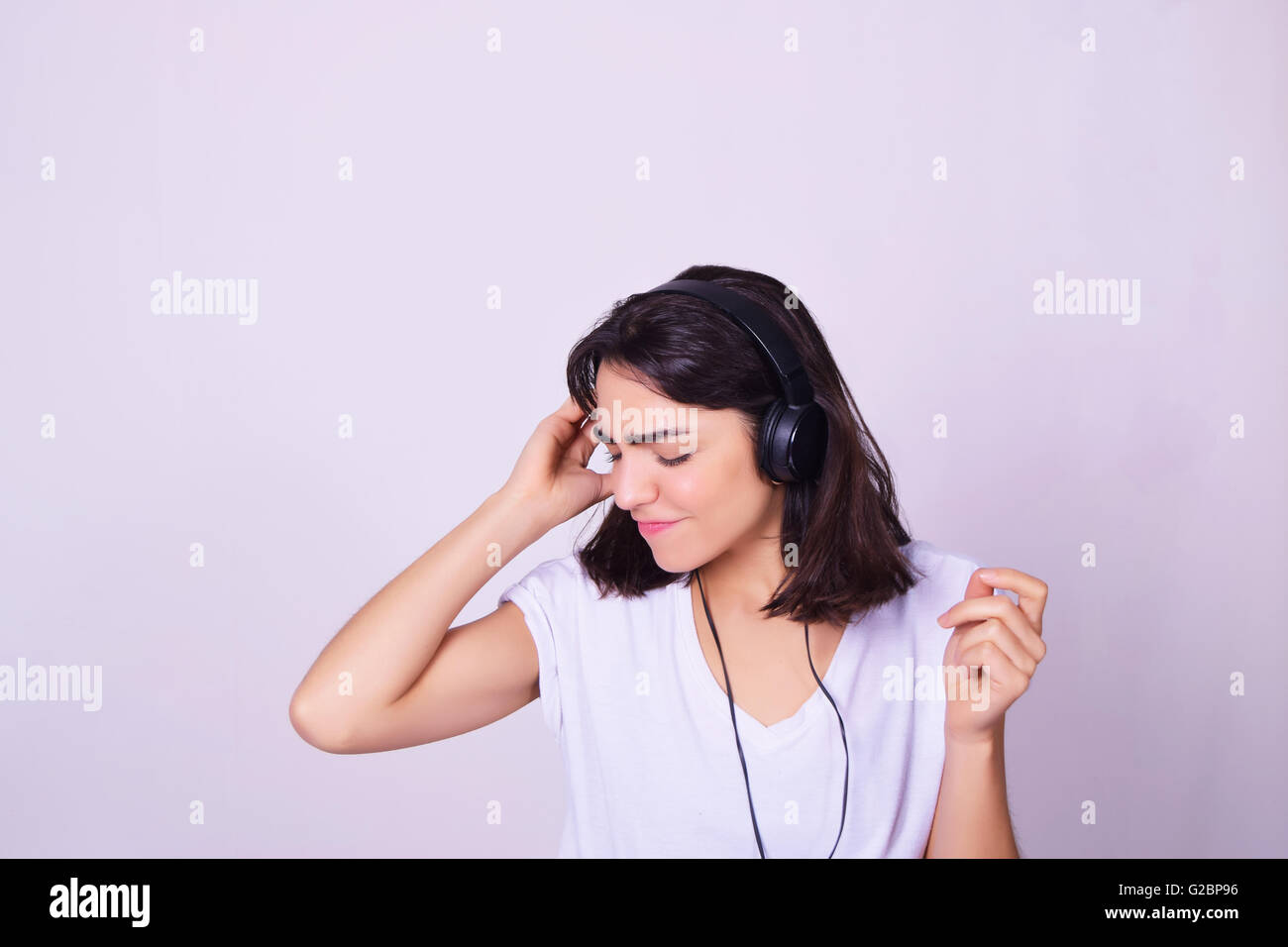 Music. Young hispanic woman listening to music with headphones. Playful ...