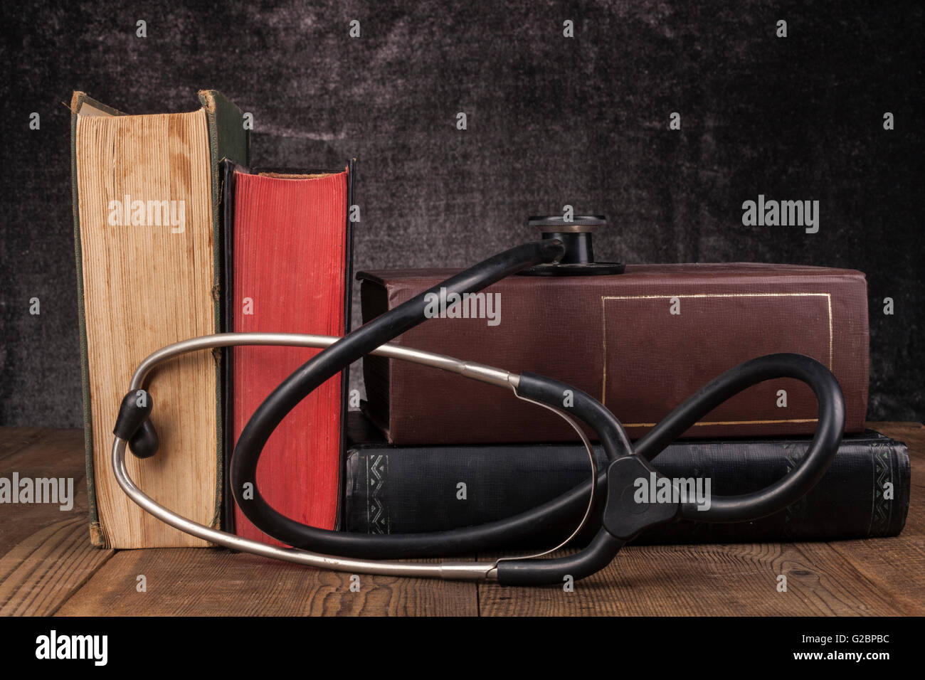Old Books on Wood Table with Black Stethoscope Stock Photo - Alamy
