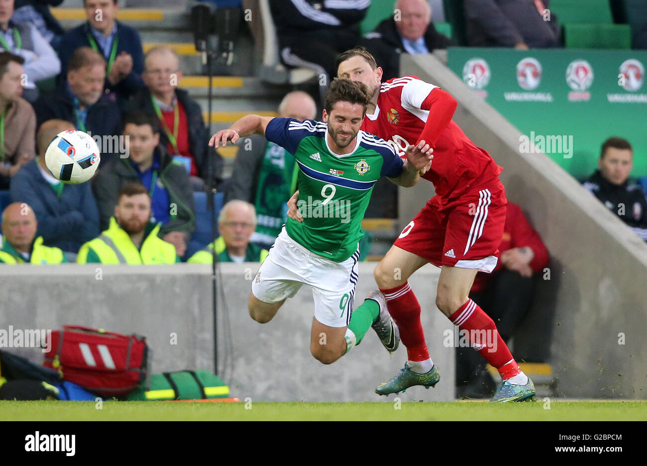 Northern Ireland's Will Grigg (left) is challenged by Belarus' Mikhail Sivakov during the International Friendly at Windsor Park, Belfast. Stock Photo