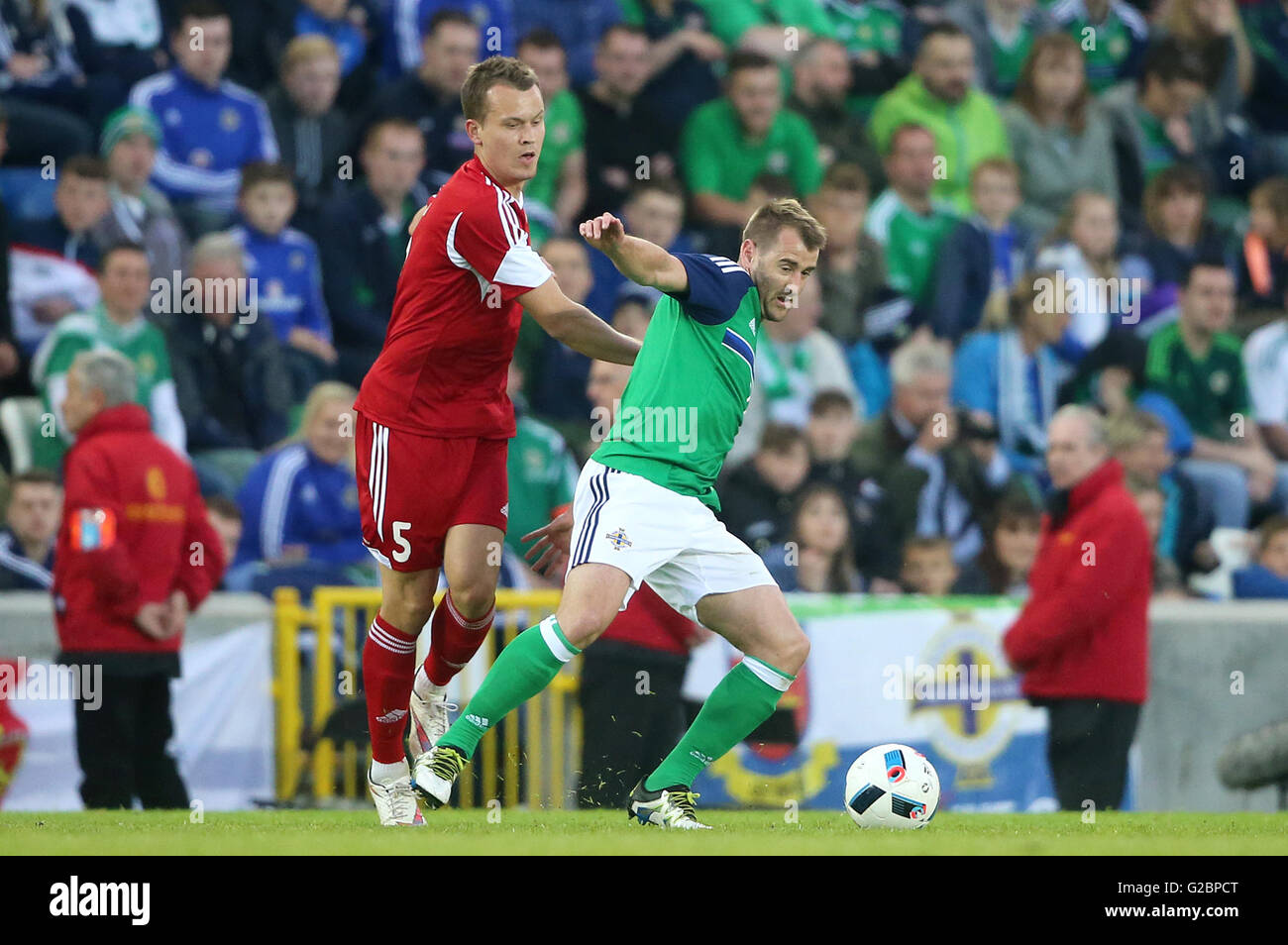 Northern Ireland's Niall McGinn (right) and Belarus' Denis Polyakov battle for the ball during the International Friendly at Windsor Park, Belfast. Stock Photo