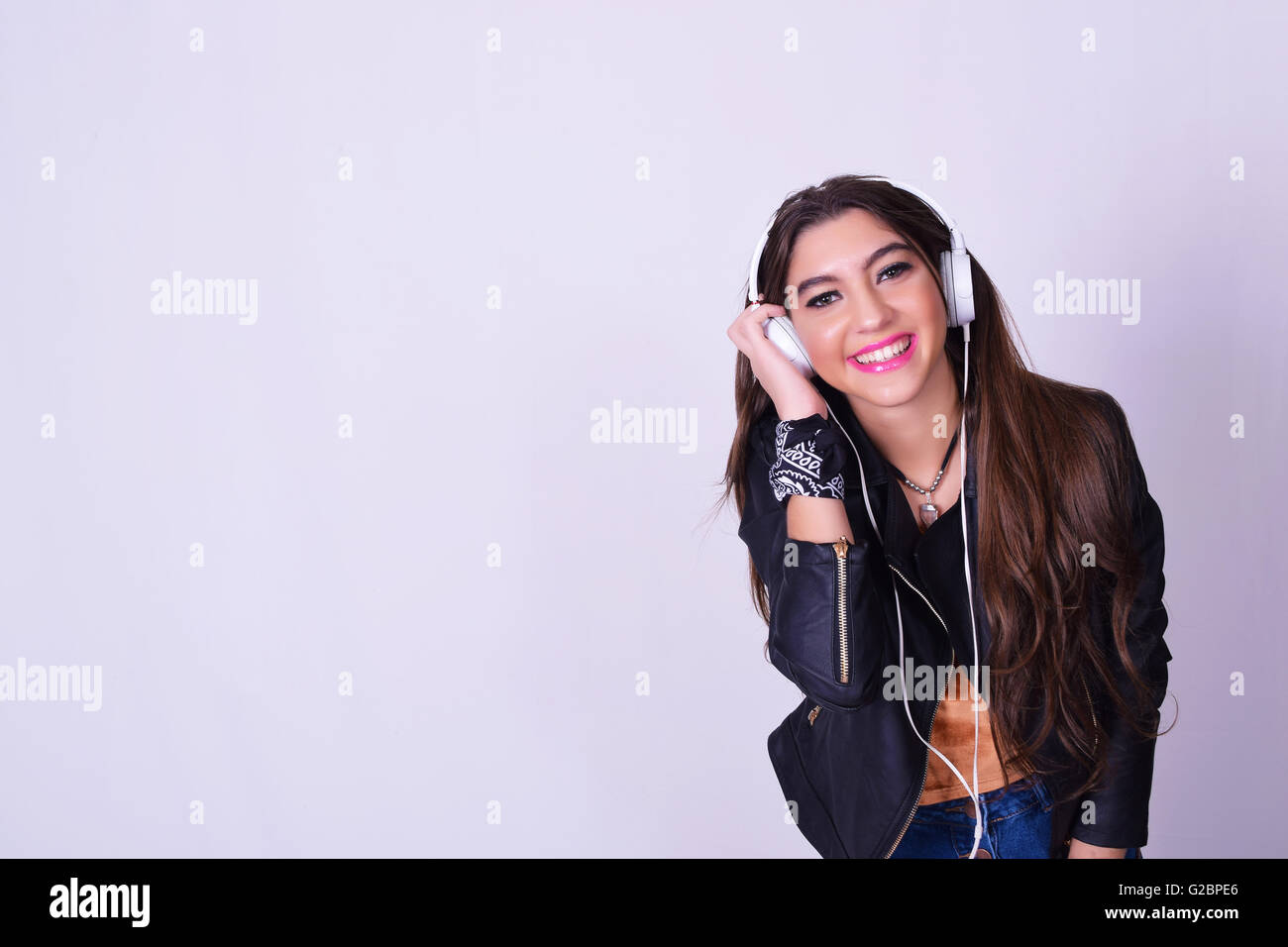 Music. Young hispanic woman listening to music with headphones. Playful ...