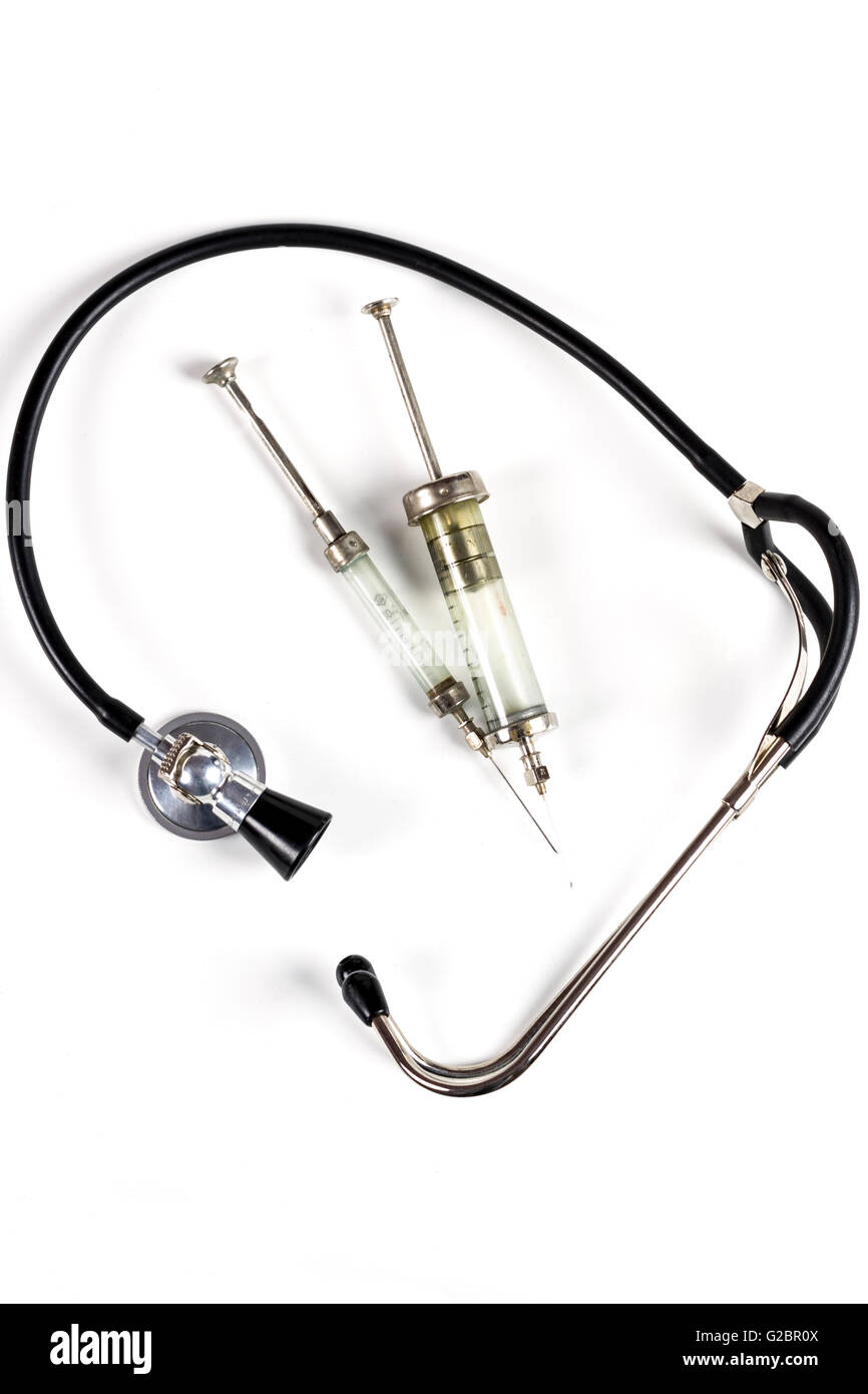 Glass Syringe With Black Old Stethoscope on White Background Stock Photo