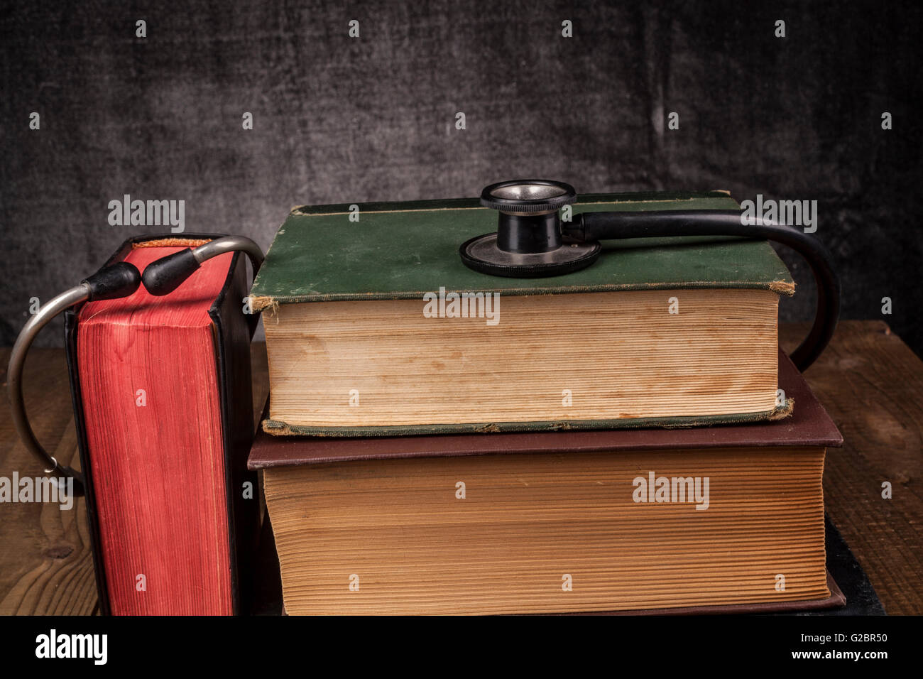 Old Books on Wood Table with Black Stethoscope Stock Photo - Alamy