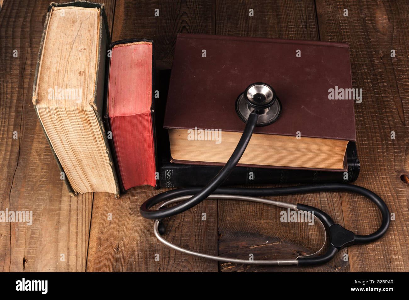 Old Books on Wood Table with Black Stethoscope Stock Photo - Alamy
