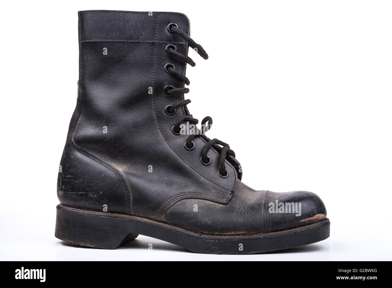 One Black Dirty army boot isolated on white background Stock Photo - Alamy