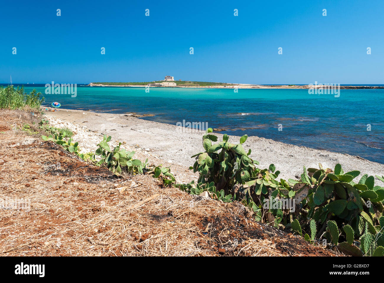 The coastline near Portopalo (Sicily), and the island of Capo Passero in the background Stock Photo