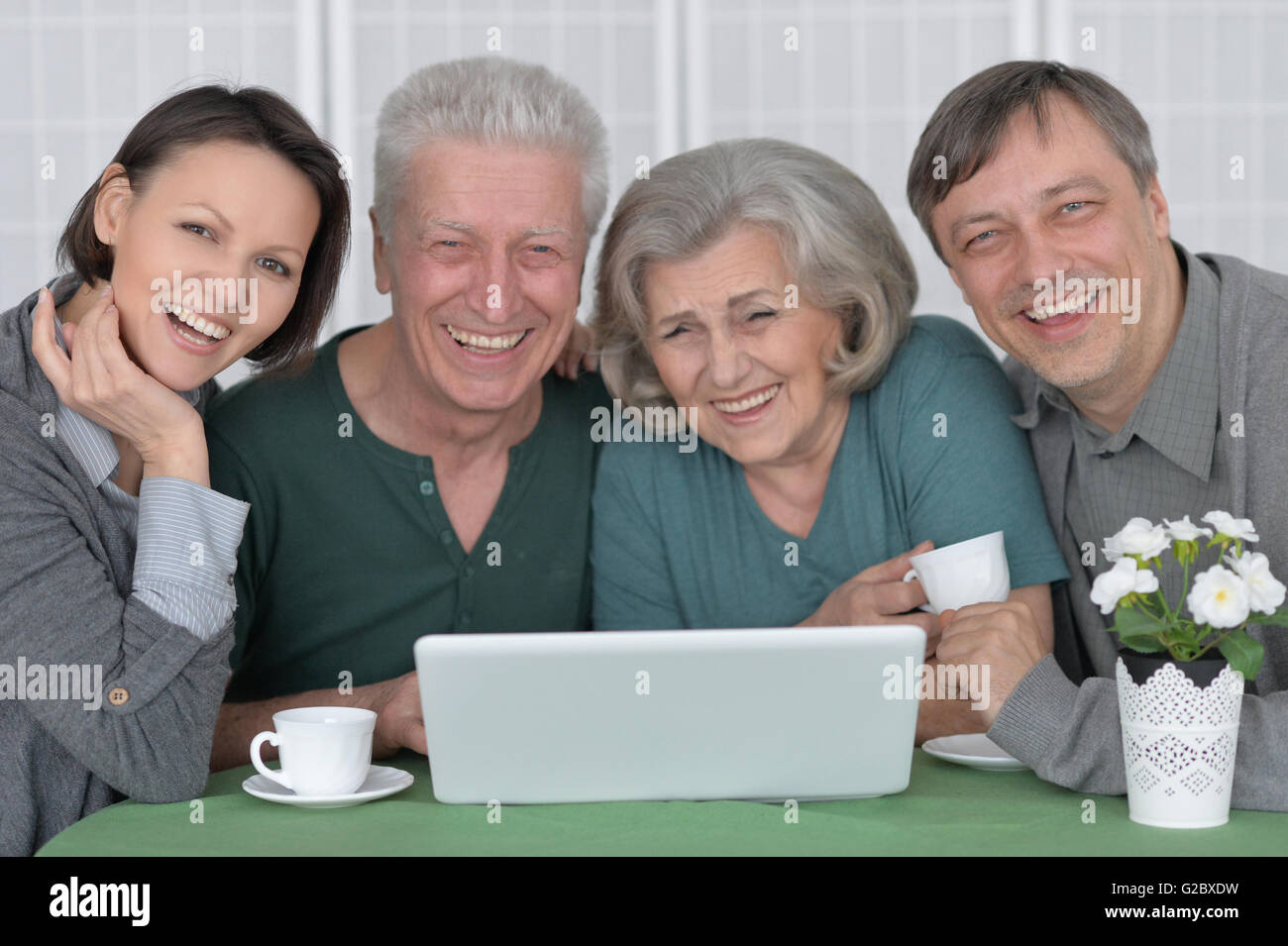 Happy smiling family with laptop Stock Photo - Alamy