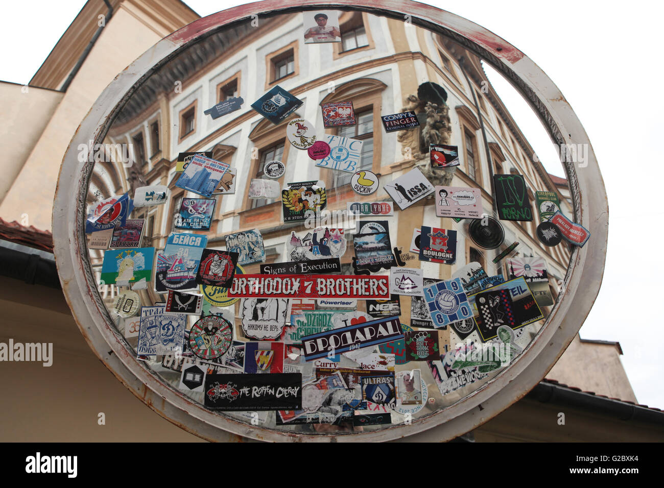 Convex mirror covered with stickers at Hradcanske Square in Prague, Czech Republic. Stock Photo