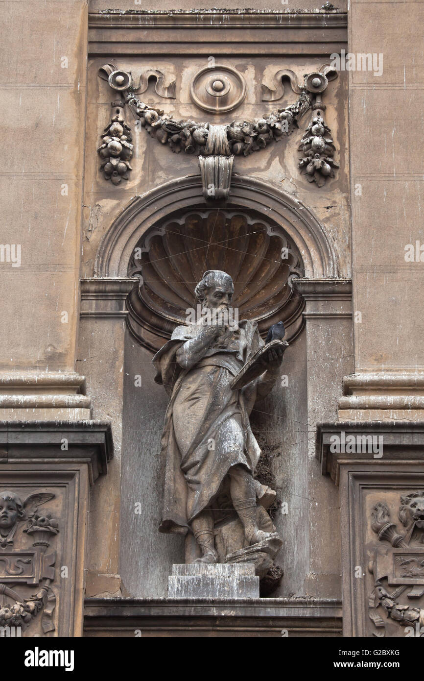 Elderly man holding fossils. Statue covered with bird droppings on the
