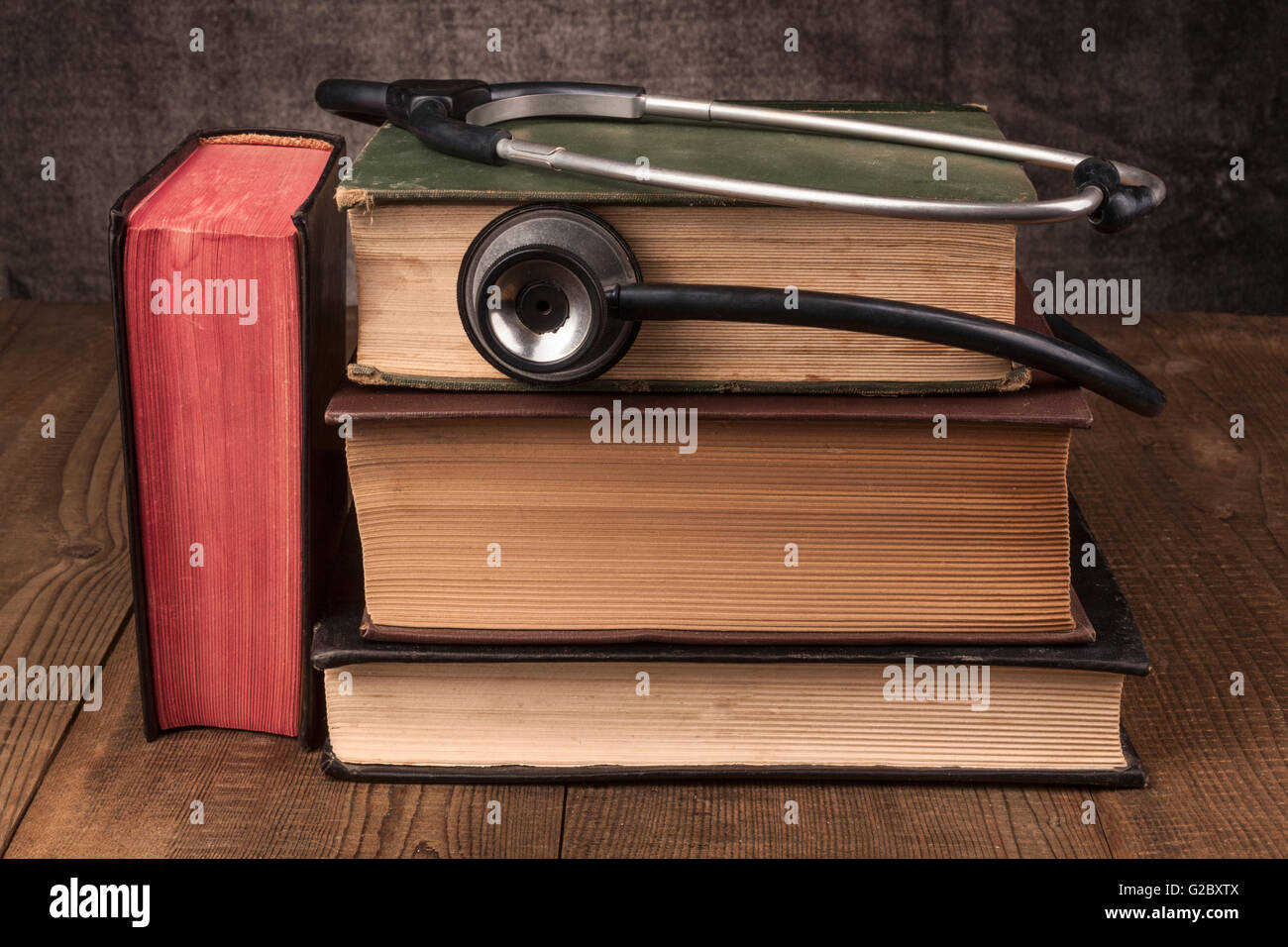 Old Books on Wood Table With Stethoscope Stock Photo - Alamy